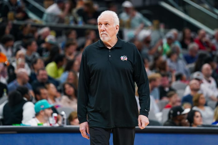 San Antonio Spurs coach Gregg Popovich walks on the court at Frost Bank Center during a game.